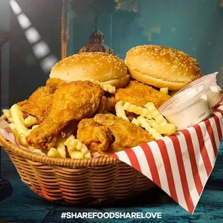 A basket of broast, buns, fries, and dip.